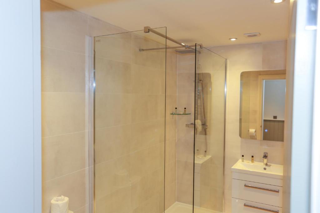 a bathroom with a shower and a sink at Duck Bay Hotel & Restaurant in Balloch