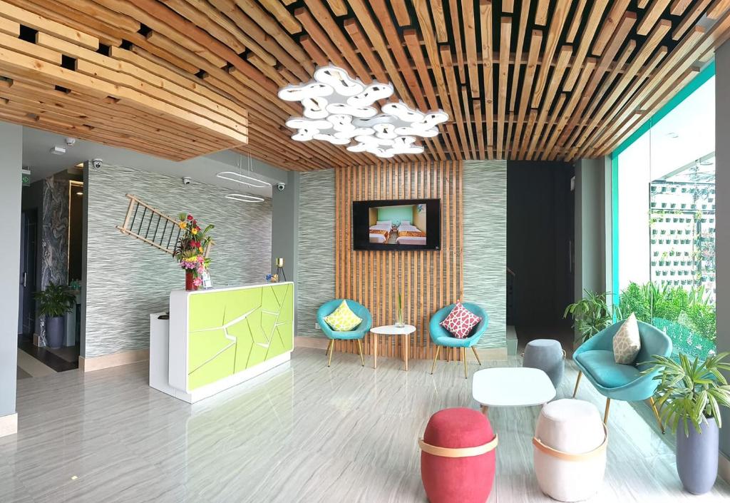 a lobby with chairs and a table and a chandelier at Felicity Island Hotel in Mactan