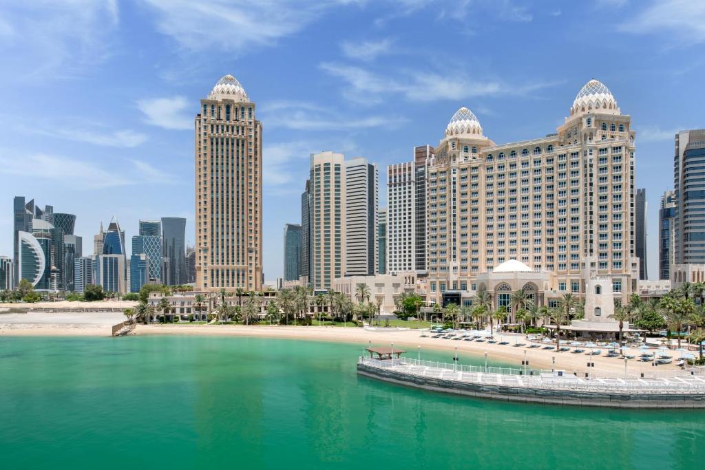 a view of a city with tall buildings and a body of water at Four Seasons Hotel Doha in Doha