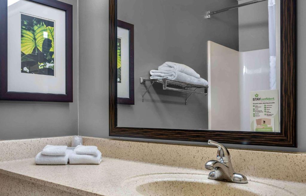 a bathroom with a sink and a mirror and towels at Extended Stay America Suites - Providence - Warwick in Warwick