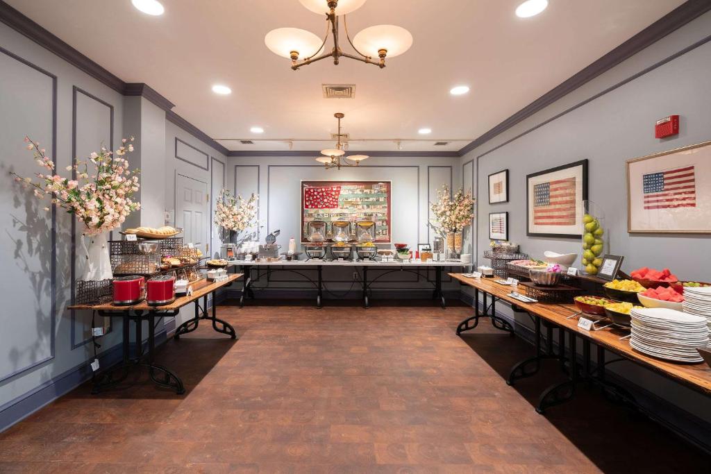 a restaurant with a buffet of food on tables at The Kendall Hotel at the Engine 7 Firehouse in Cambridge