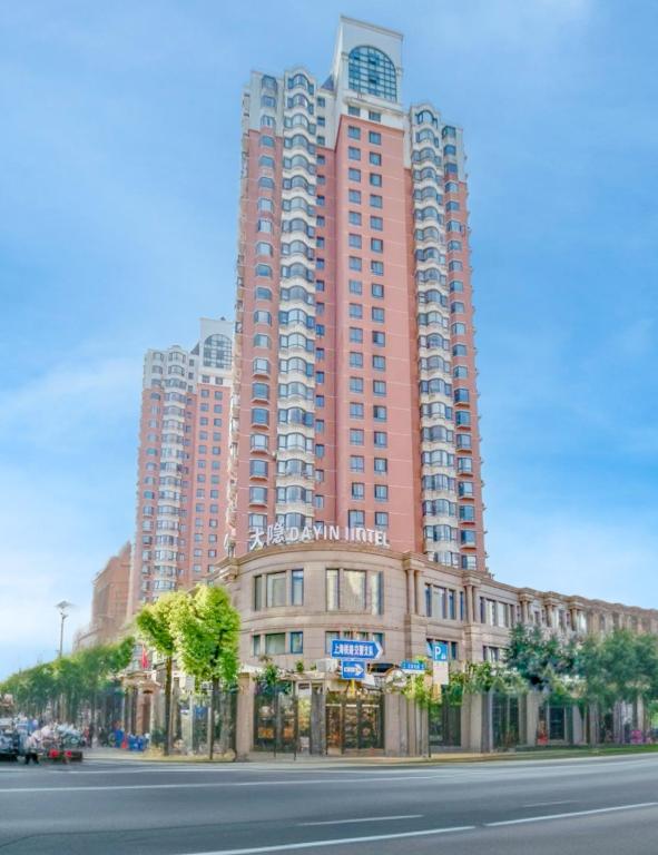 a large red building on the side of a street at Dayin Garden Hotel -Near People's Square & Nanjing Road-Large Social Area -Bar -Café -Gym -Free Laundry Luggage Storage -24H Front Desk-English Service in Shanghai