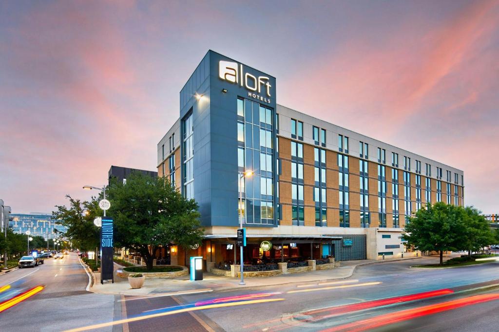 a building with a sign on it on a city street at Aloft Austin at The Domain in Austin