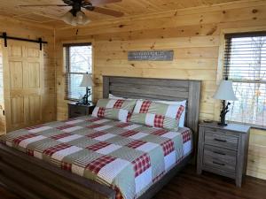 a bedroom with a bed in a log cabin at A View from the Top in Sevierville +37 photos