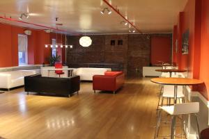 a large room with tables and couches and chairs at HI New York City Hostel in New York