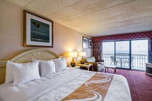 a hotel room with a bed and a view of the ocean at Quality Inn Oceanfront in Ocean City +37 photos