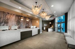 an office lobby with a reception desk and chandeliers at Bay View Resort Myrtle Beach in Myrtle Beach +37 photos
