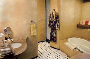 a bathroom with a sink and a bath tub at El Portal Sedona Hotel in Sedona +37 photos