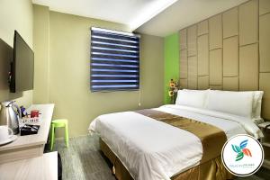a bedroom with a large bed and a window at Felicity Island Hotel in Mactan