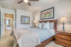 a bedroom with a bed and a dresser with two lamps at Deschutes Landing at the Old Mill Riverfront - Meredith Lodging in Bend