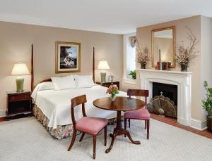 a bedroom with a bed and a table and chairs at John Rutledge House Inn in Charleston