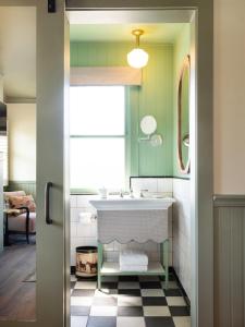 a bathroom with a sink and a mirror at Le Petit Pali at 8th Ave in Carmel +37 photos