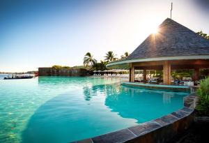 a swimming pool at a resort with a gazebo at Te Moana Tahiti Resort in Punaauia