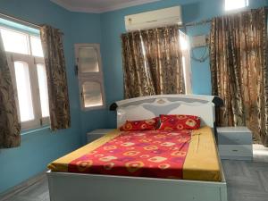 a bedroom with a bed in a blue room at MOON HAVELI in Bikaner