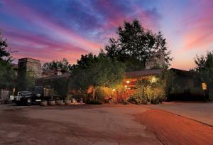a truck parked in front of a house at sunset at El Portal Sedona Hotel in Sedona