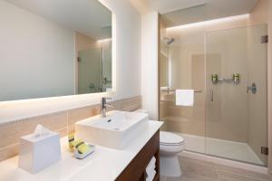 a bathroom with a sink and a toilet and a shower at Element Minneapolis Downtown North Loop in Minneapolis +29 photos