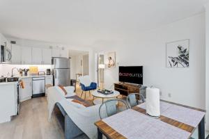 a kitchen and living room with a table and chairs at 2BR 3BA Condo On The Boardwalk CozySuites in Atlantic City