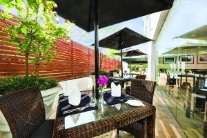 a table with chairs and an umbrella in a restaurant at Fair View Hotel Colombo in Colombo