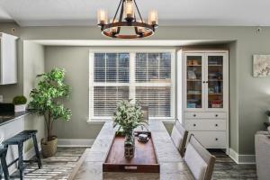 a dining room with a table and chairs at 2BR Condo - Near SDC - 2 Pools - Golf Onsite - FREE TICKETS INCLUDED - SB 9-5 in Branson