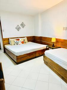 a bedroom with two beds and a lamp in it at Casa Generosa in Baguio +37 photos