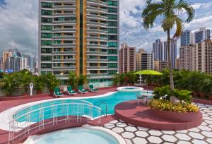 a swimming pool on the roof of a building at Hospedium Princess Hotel Panamá in Panama City
