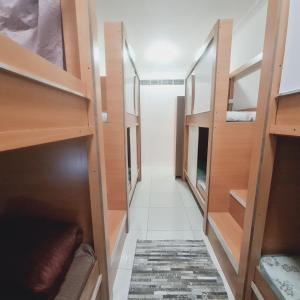 a hallway with wooden shelves and a rug at LA Gold hostel capsule in Dubai +11 photos