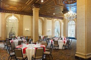 a banquet hall with tables and chairs and chandeliers at Marriott Syracuse Downtown in Syracuse