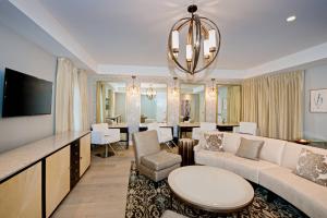 a living room with a couch and a dining room at Marriott Syracuse Downtown in Syracuse