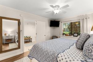 a bedroom with a bed and a mirror at Fairways 228 "Bluegrass Bungalow" in Destin +37 photos