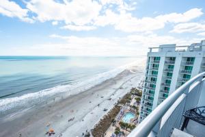 a view of the beach from the balcony of a resort at Myrtle Beach Oceanfront Condo with Stunning Views in Myrtle Beach
