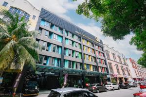 a large building on a city street with cars parked at Swing & Pillows - TAR UMT Setapak in Kuala Lumpur