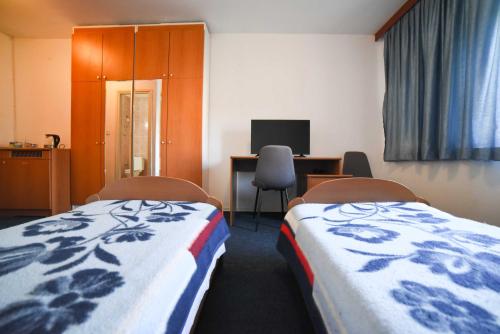 a hospital room with two beds and a desk with a computer at Guest House Duje in Split