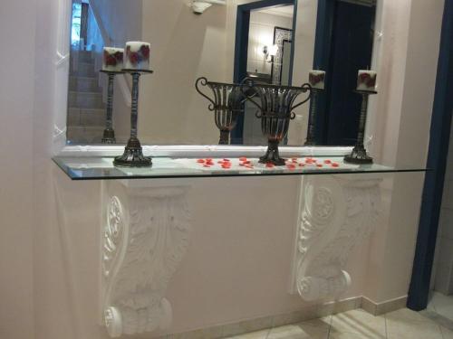 a bath tub with a glass counter with roses on it at Florena Hotel in Nikiana