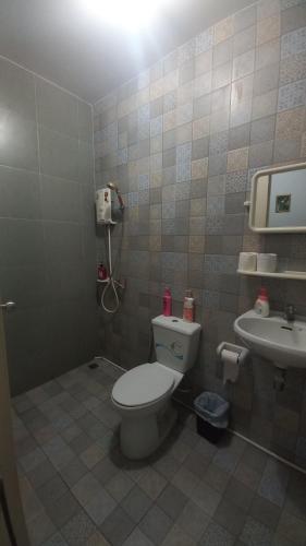 a bathroom with a toilet and a sink at Amaretto Hostel in Suratthani