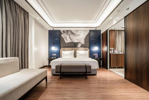 a hotel room with a bed and a couch at Radisson Blu Hotel Ahmedabad in Ahmedabad