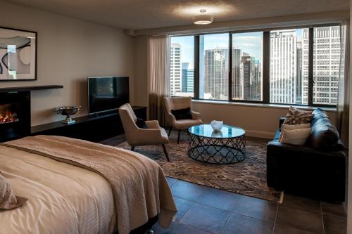 a hotel room with a bed and a view of a city at Suite 11 Victoria Square in Adelaide
